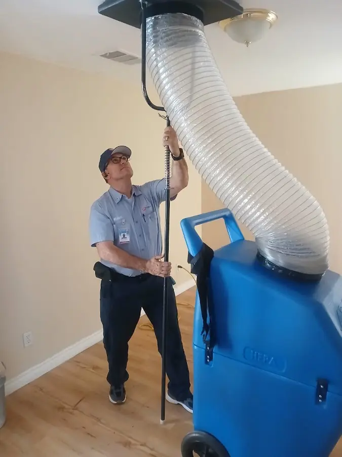 Furnace Tune-Up technician using HEPA equipment in Winfield